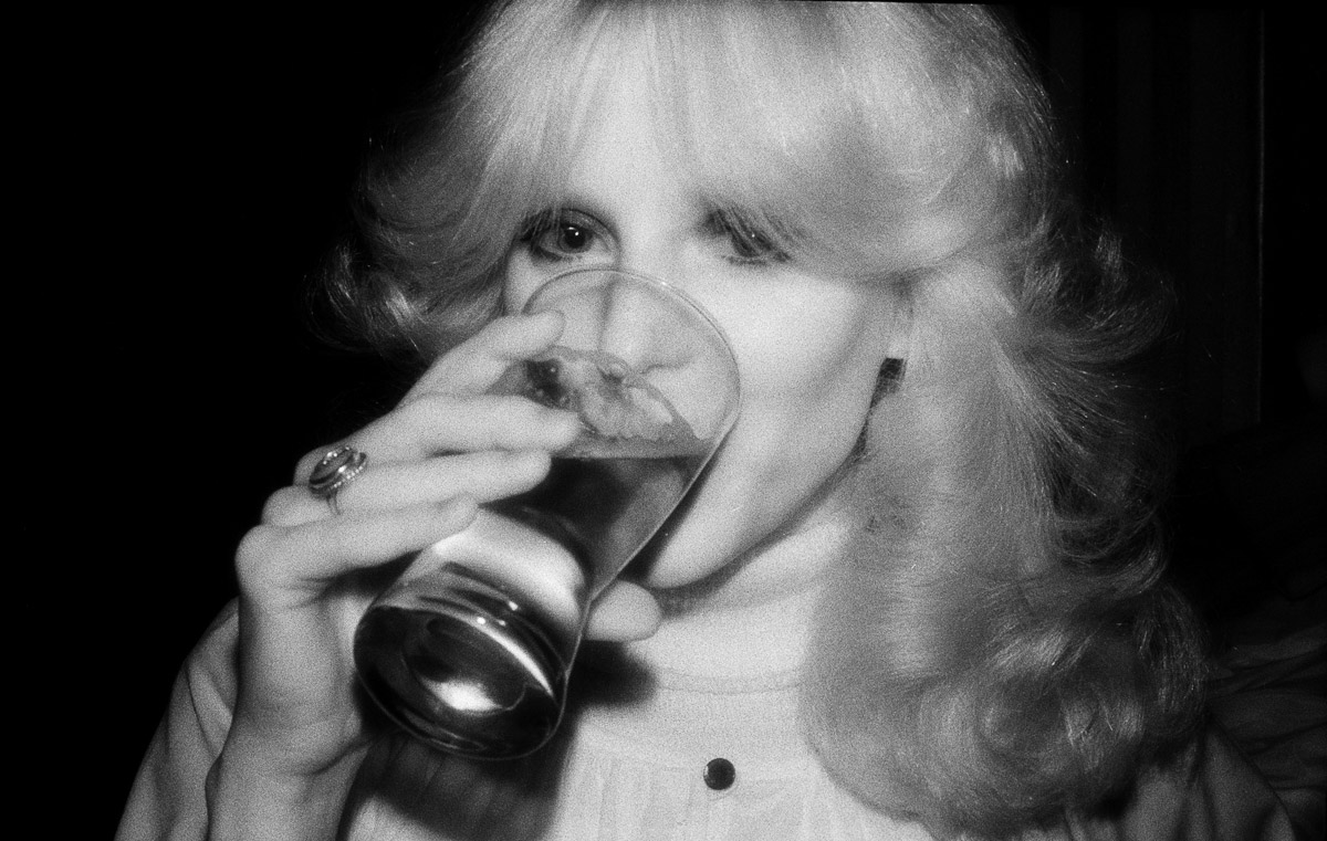 Woman in bar with glass